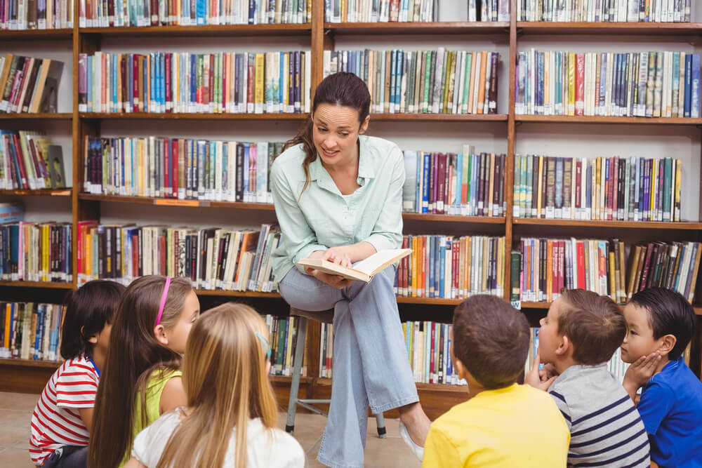 Teacher reading her pupils a story at the elementary school